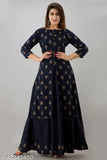 Woman wearing blue gold printed kurta and skirt with straight cut, standing against a grey background