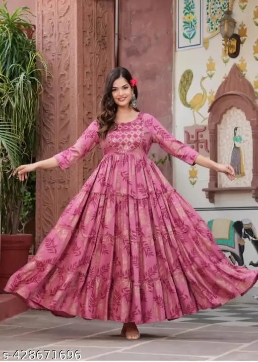 Pink anarkali dress with flared sleeves and intricate embroidery