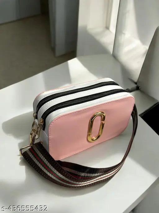 Pink wallet with braided strap and gold zipper, featuring two card slots