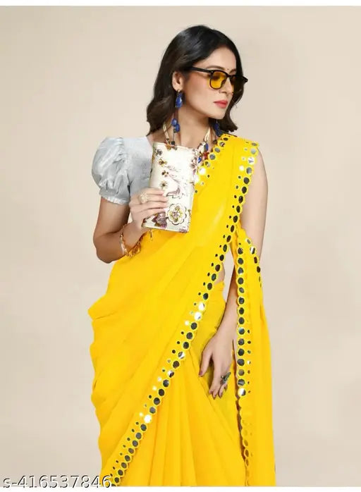 Yellow georgette saree with mirror embellishments, sleeveless design