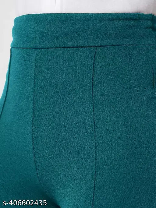 Stylish vintage ladies high-rise bell-bottom trousers, teal velvet material