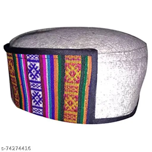 Handwoven, Himachal-style beige cap with traditional striped trim and pompom