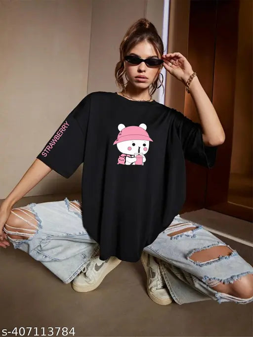 Black oversize t-shirt featuring a graphic of a white cat with pink ears and eyes, inscribed with a pink text