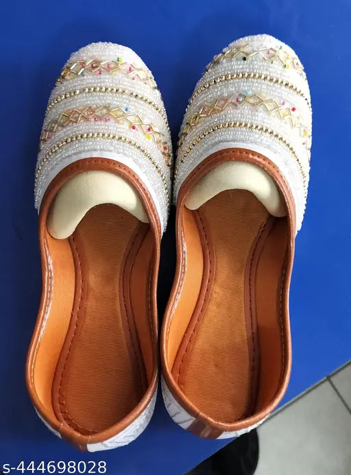 White embroidered women's jooti with diamonds and stone embellishments, brown soles