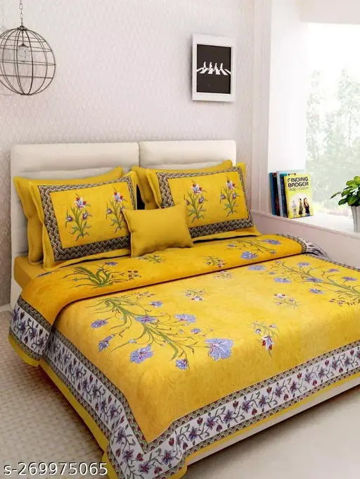 Yellow cotton bedsheet set with floral print, includes 1 sheet and 2 pillow covers.