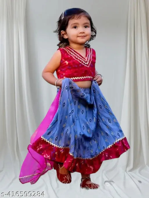 Bright printed cotton lehenga-choli-dupatta set on Indian backdrop, featuring net dupatta for young girls, aged 12-24 months and 5-6 years