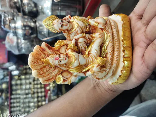Resin statue of Shree Laxmi and Narayana, gold-colored with intricate details