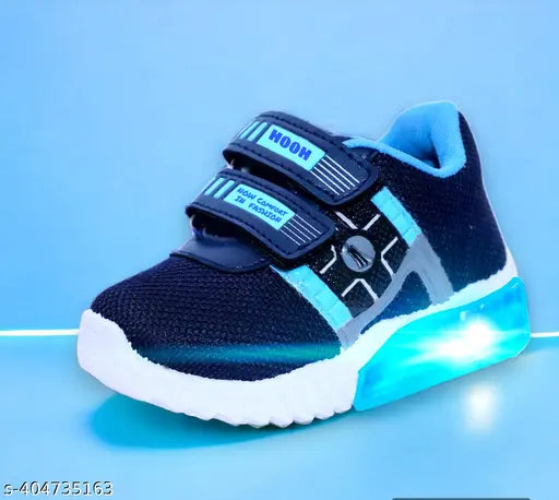 The image displays a pair of sports shoes with a blue colorway, black straps, and a chunky sole design. They appear waterproof and suitable for casual wear or sporting activities. The shoes have a comfortable appearance, likely designed for comfort and style. The image is brightly lit, showcasing the shoes' details against a contrasting background