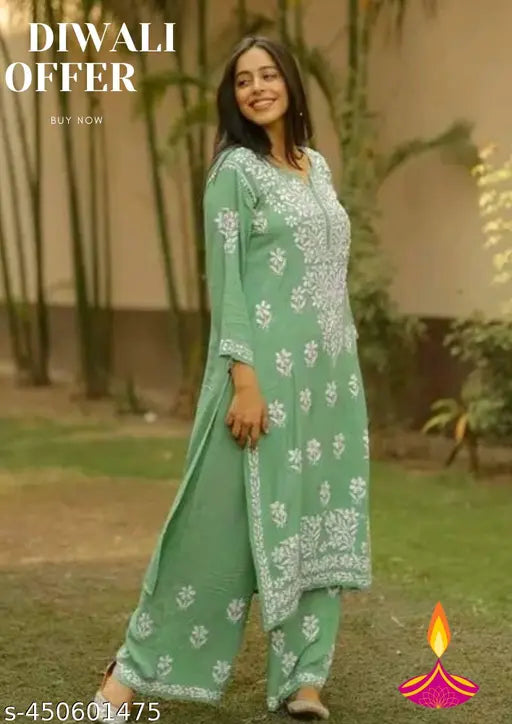 Rayon Chikankari work kurta and palazzo set with embroidered net pattern, three-quarter sleeves, and matching bottomwear. Size options: M-6XL (India)