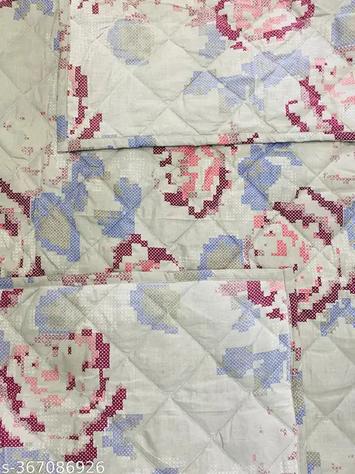 Floral quilt with intricate pattern, possibly handmade