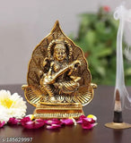 Golden Maa Saraswati figurine with antique finish, set against leaf backdrop, 13cm metal