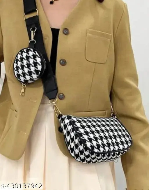 Tan tweed blazer with checkered shoulder straps and black purse with houndstooth pattern