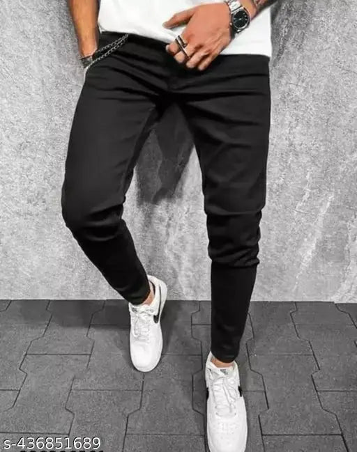 Black skinny fit jeans with cuffs rolled up, black and white sneakers