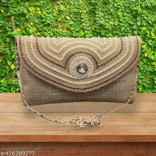 Brown woven fabric clutch with large embellishments and multiple openings