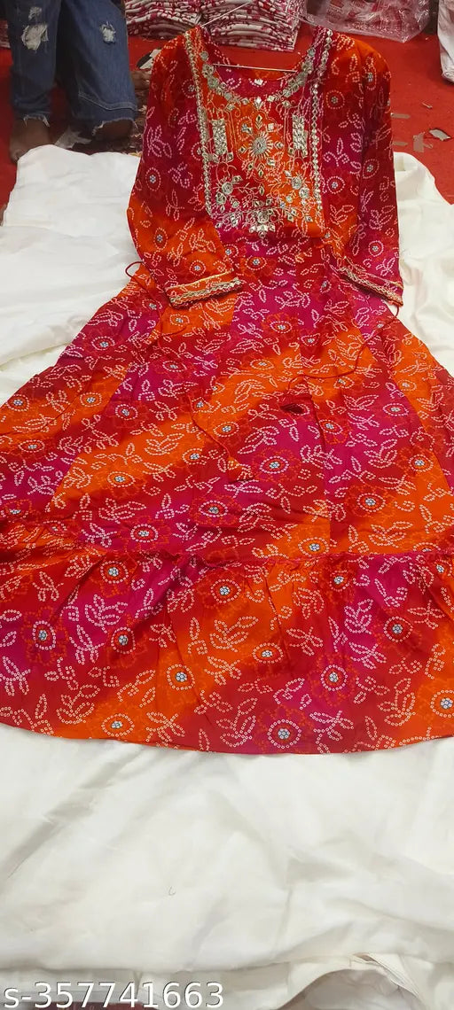 Red bandhani printed kurti with three-quarter sleeves, stitched neckline