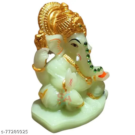 Green glass sculpture of Lord Ganesha, radiating light, 4 inches
