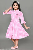 Pink checkered dress with ruffled sleeves and skirt, young girl pose