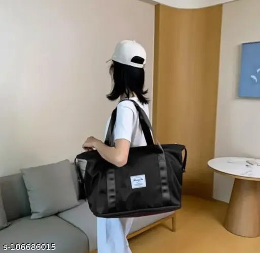 Black nylon travel bag with side pockets and adjustable strap