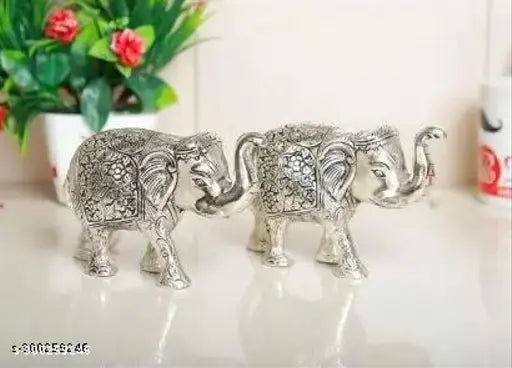 Metal handcrafted, silver-polished Chandra Art Collection small size elephant statues set - 14 cm (L) x 8.5 cm (H) x 6 cm (B), perfect for home or office decoration and gifting articles. Symbolizing wisdom, strength, and good luck in Indian culture