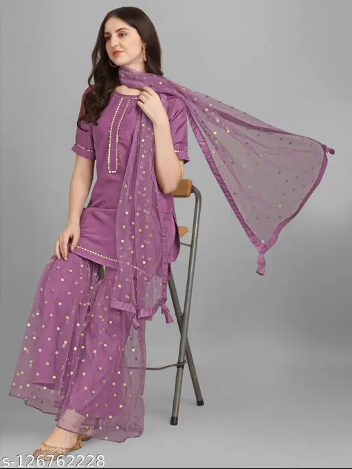 A person wearing a purple dupatta with kurta and sharara set