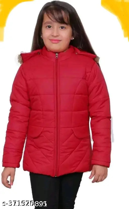 A young girl wearing a red puffer jacket with a hood, standing against a plain background