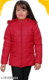 A young girl wearing a red puffer jacket with a hood, standing against a plain background