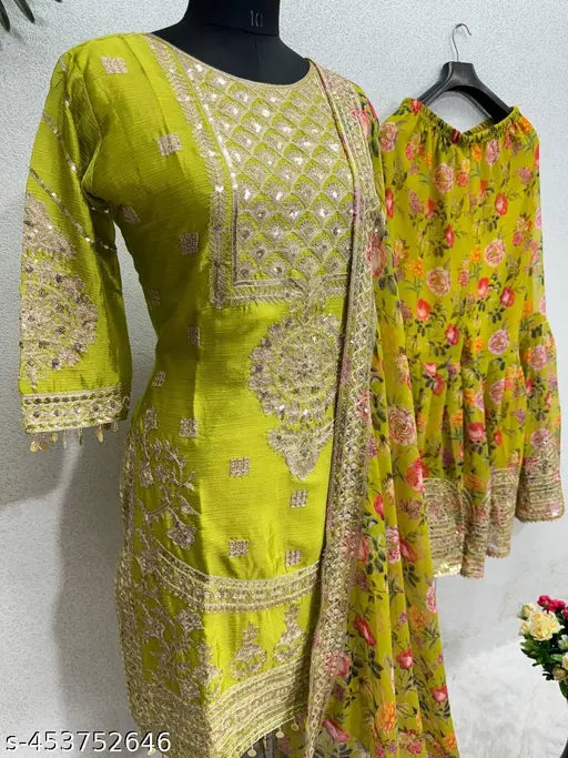 Green and gold formal outfit with detailed embroidery