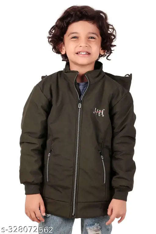 A young boy standing outside in a dark green jacket with white stripe details