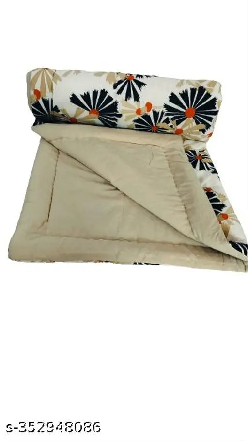 Multi-color printed cotton baby quilt, vibrant and cozy for crib use in mild winter. Handmade by Taj Overseas, India." (123 characters)