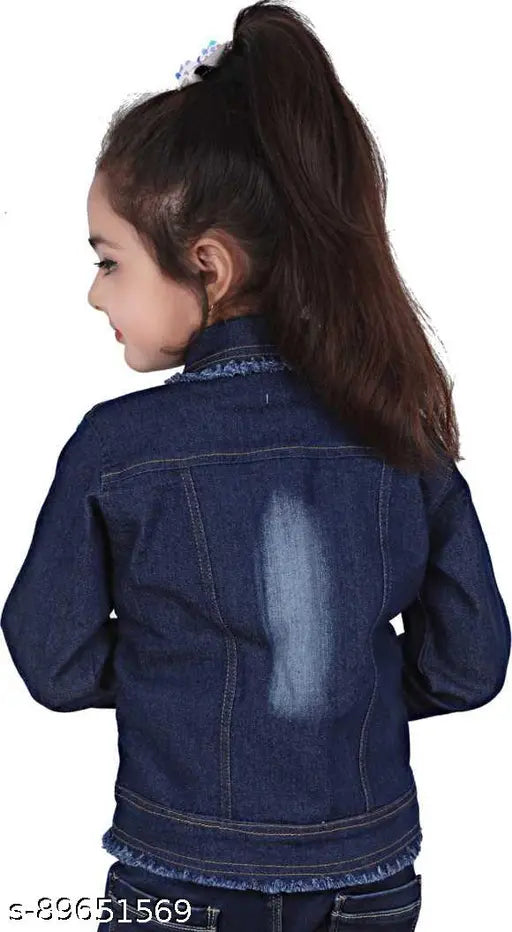 Little girl wearing a denim jacket with an iron on it