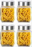 Six clear glass jars, each with a silver lid, containing yellow macaroni in a pack, for kitchen use