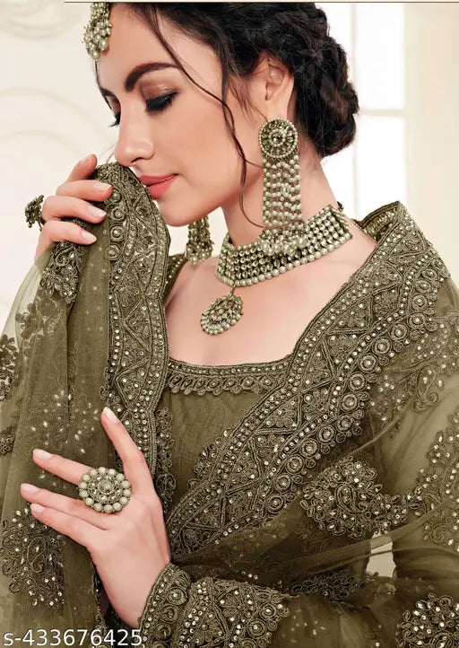 Embroidered net lehenga choli and dupatta set, featuring trendy chain detailing. Free size up to 2XL, semi-stitched. Indian fashion accessory