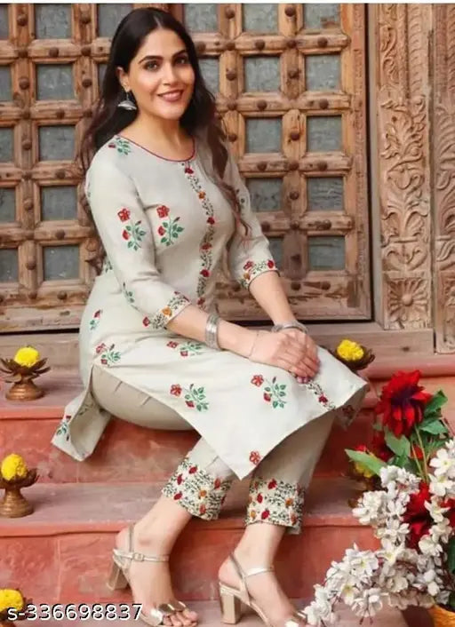 Woman's formal embroidered kurta set, with bottom, in navy blue on porch