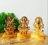 Statues of Hindu deities Lakshmi, Saraswati, and Ganesh, gold-colored, for worship in a home or temple decor, Diwali gifting suggestion