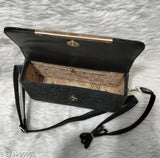 A black clutch purse with a flap closure