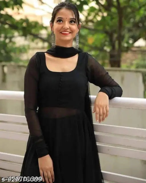 Black embroidered georgette blouse with elbow-length sleeves and V-neck, accessorized with statement earrings