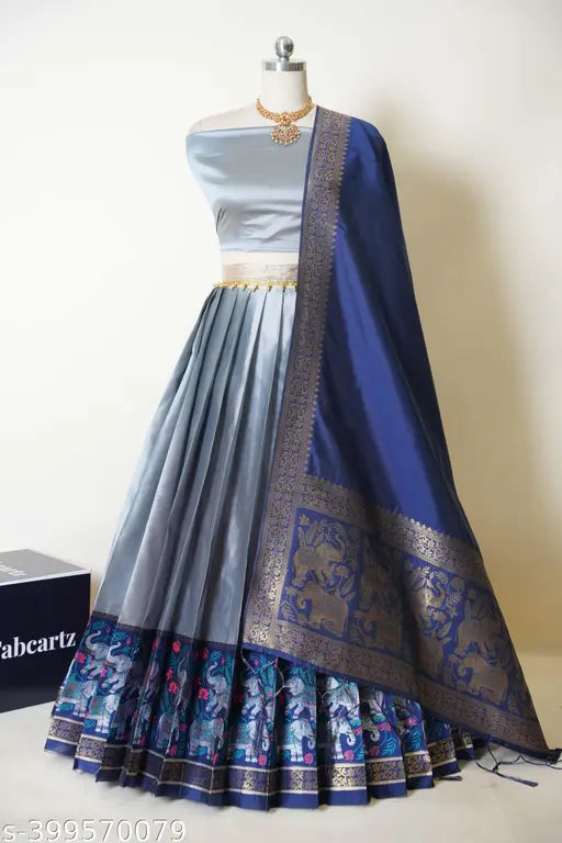 South Indian style unstitched half saree in litchi silk, featuring a solid choli and dupatta with zari work, perfect for traditional events, comes in sizes 40m/42m for the lehenga and 2.4m for the dupatta, includes tussled ends and belt. Indian-made