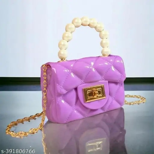 Miniature purple jelly-like sling bag, crossbody style. Ideal for trendy fashion and stylish kids