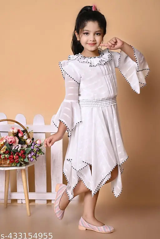 A young girl in a white lace party dress