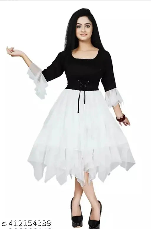 White frilly sleeveless dress with a round neck and flared skirt, below-the-knee length