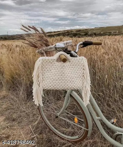 A beige macramé women's handbag with a tassel, featuring a cotton fabric