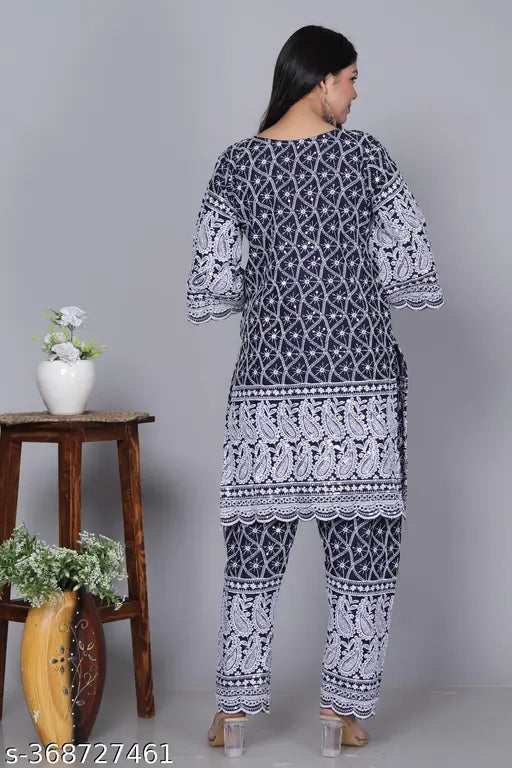 Designer DM Chikankari set, cotton blend Kurta & pants with three-quarter sleeves. Printed net, intricate hand embroidery. Lightweight, breathable fabric. Made in India