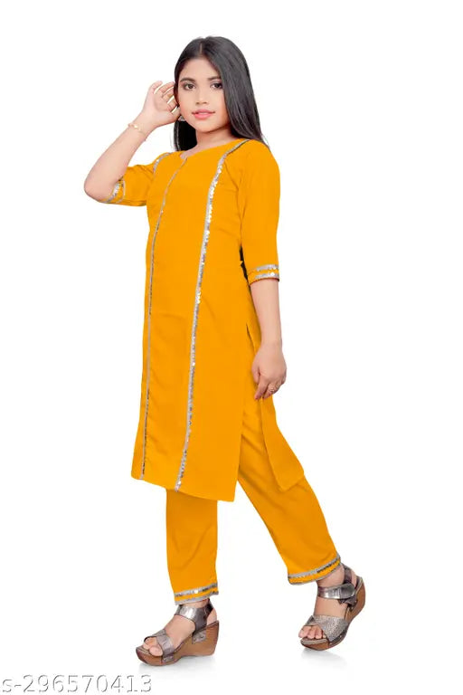 Yellow aari type lace kurti set for kids, crepe material with embellished sleeves and knee-length palazzos