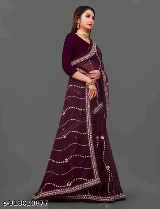 A woman wearing a maroon geo-embroidered saree with lace details and a matching blouse piece. The saree features an intricate floral pattern and is paired with a coordinating blouse, showcasing current fashion trends