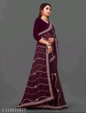 A woman wearing a maroon geo-embroidered saree with lace details and a matching blouse piece. The saree features an intricate floral pattern and is paired with a coordinating blouse, showcasing current fashion trends