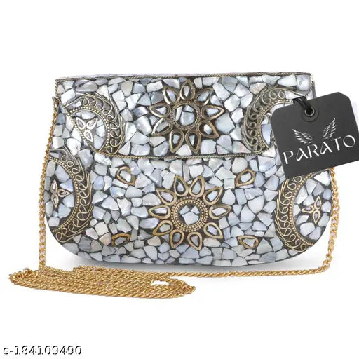 White mosaic-style handmade metal clutch purse with detachable chain shoulder strap, featuring a round sunburst pattern and a black rectangular tag, likely for sale
