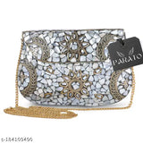 White mosaic-style handmade metal clutch purse with detachable chain shoulder strap, featuring a round sunburst pattern and a black rectangular tag, likely for sale