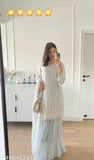 Cream lace tunic with long sleeves and ruffled hem