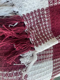 Red, white, and blue woven throw blanket with fringe ends