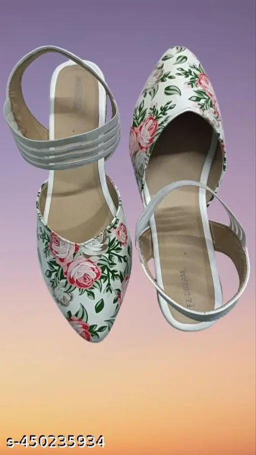 Black heeled sandal with floral design on top of foot